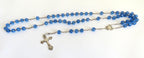 Blue rosary with a cross on a white background
