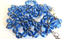 Blue beads rosary on a white background