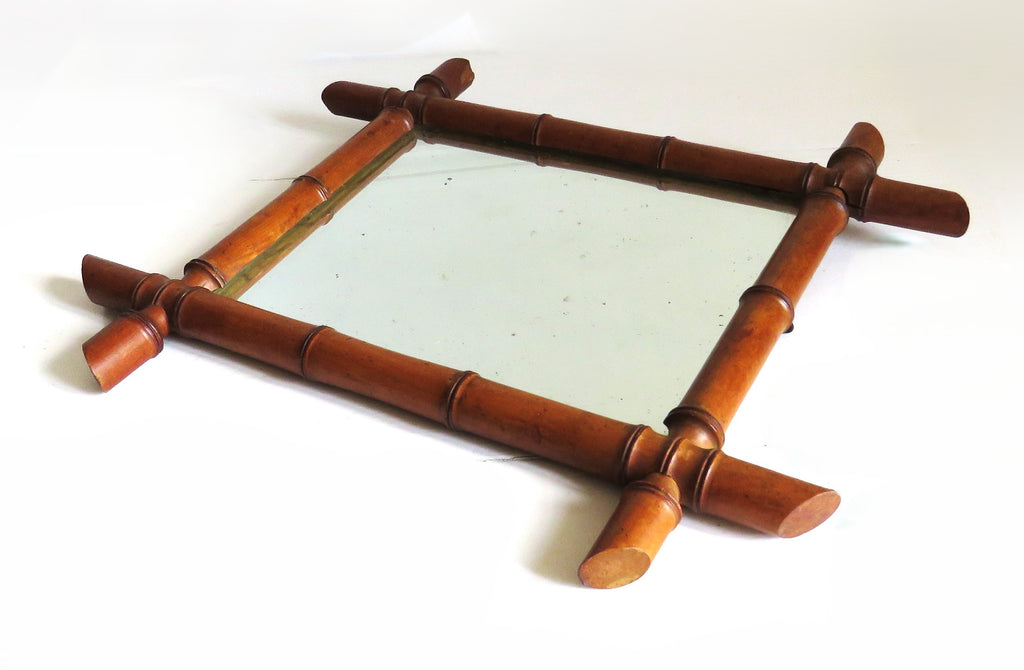Vintage French mirror with a bamboo frame on a white background
