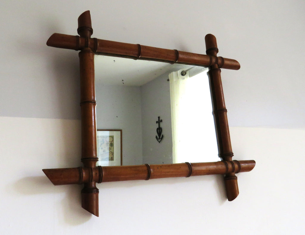 Vintage French mirror with a bamboo frame on a white background