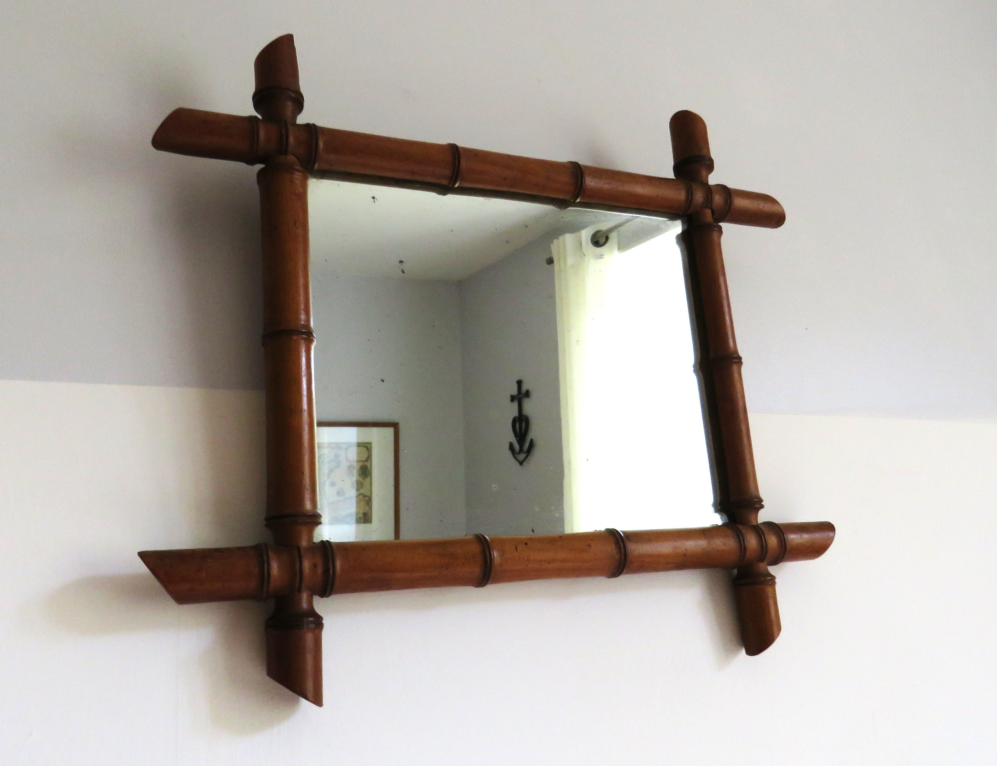 Vintage French mirror with a bamboo frame on a white background