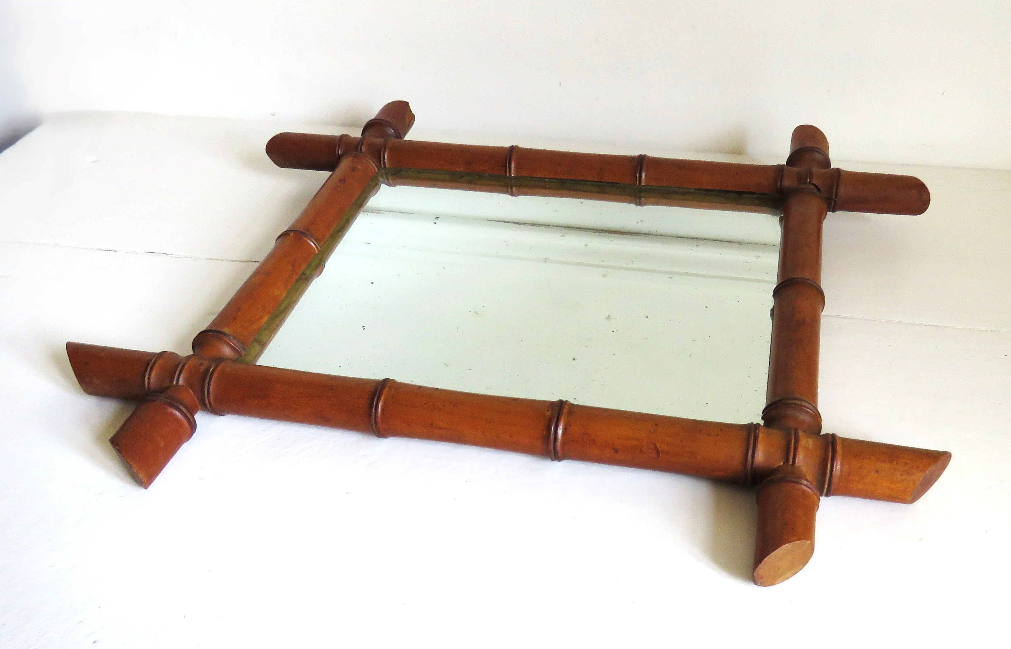 Vintage French mirror with a bamboo frame on a white background