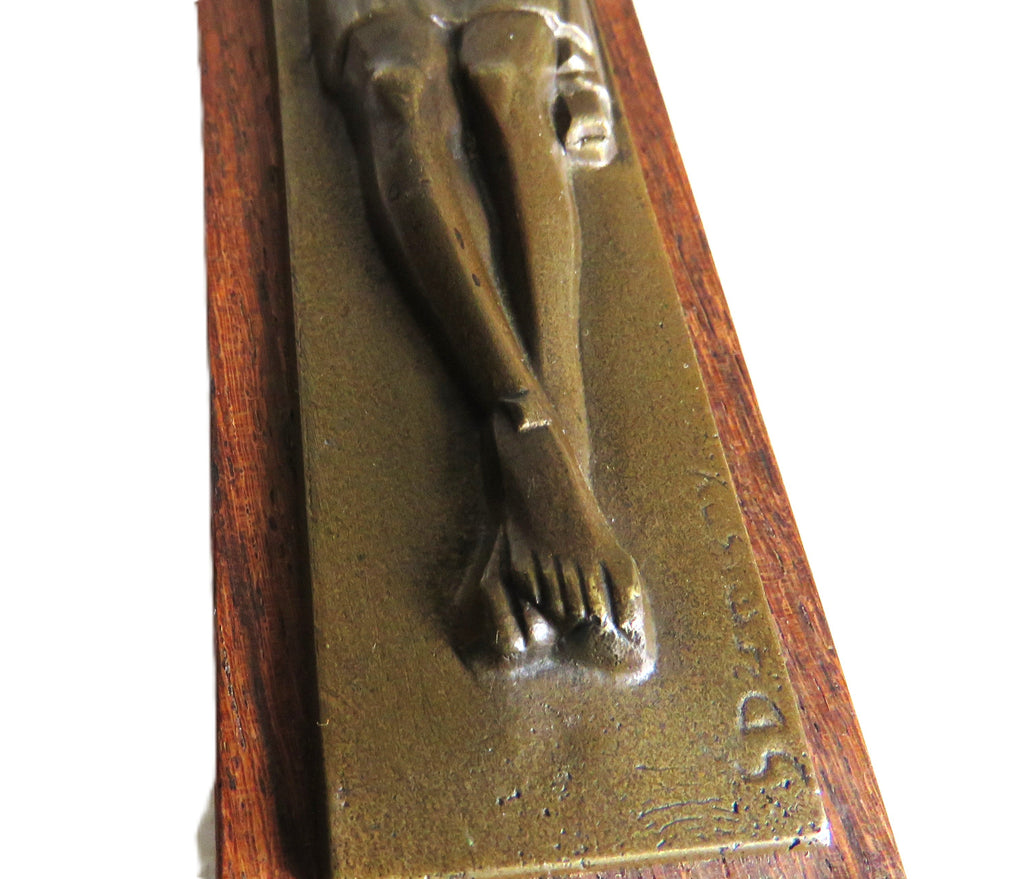 Bronze sculpture of a figure on a wooden base
