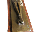 Bronze sculpture of a figure on a wooden base