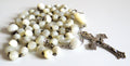Mother of pearl rosary with silver crucifix on a wite background