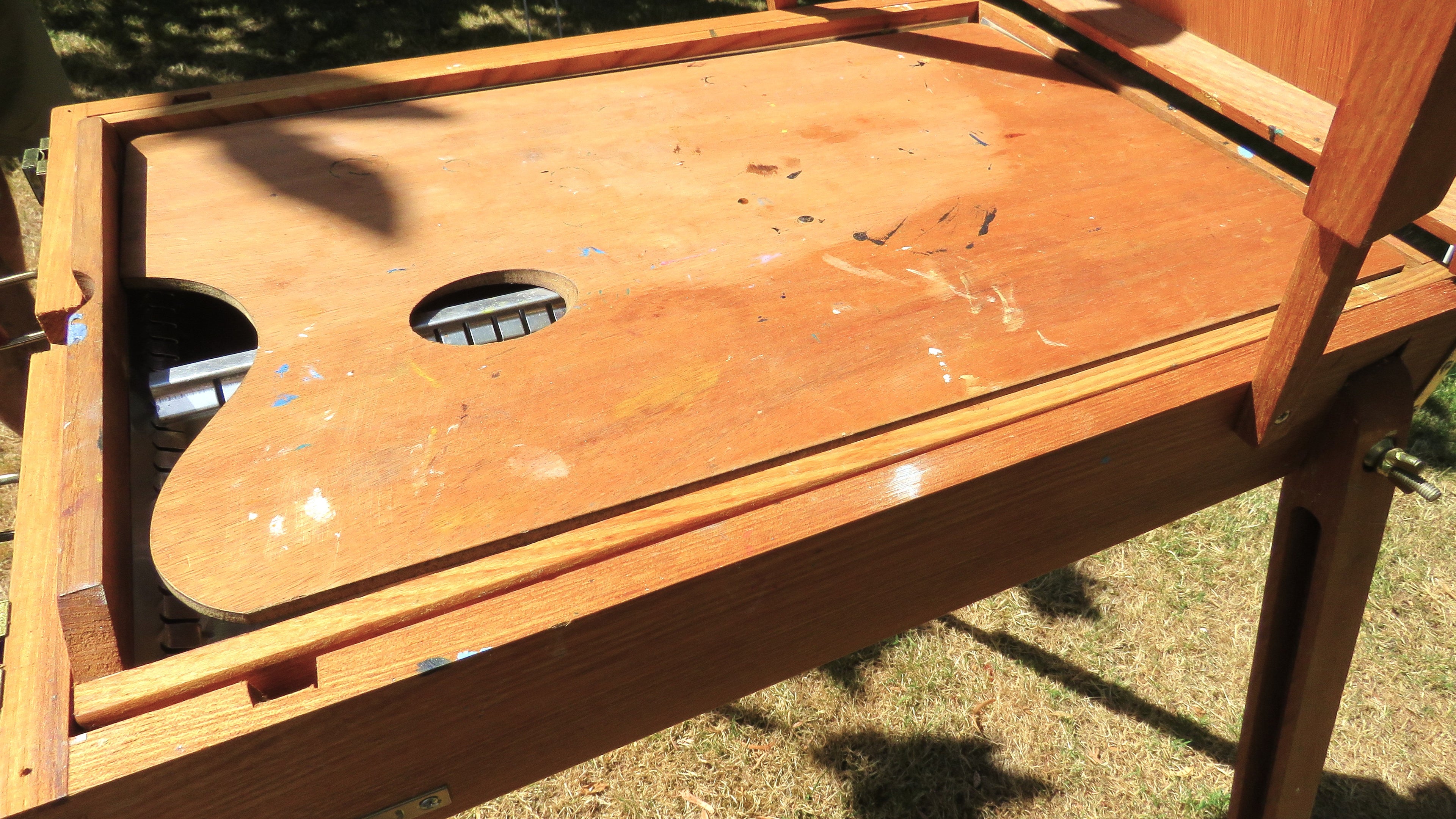 Wooden artist's easel in a garden setting palette view