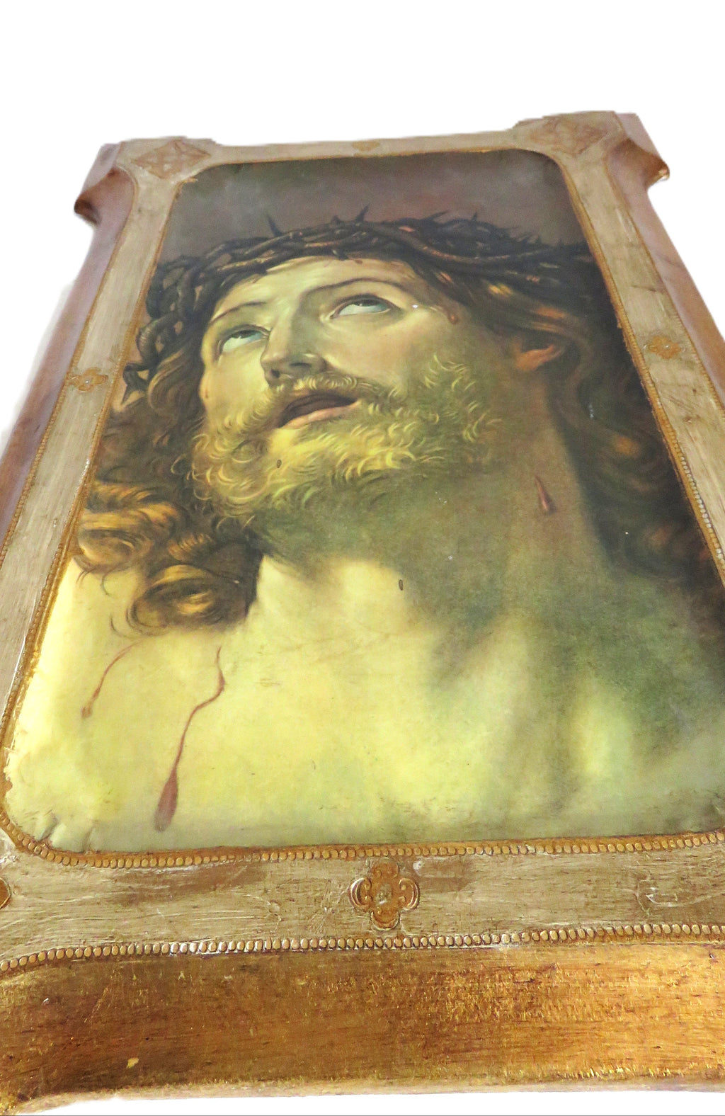 Vintage portrait of a Christ with a crown of thorns in a wooden frame on a white background