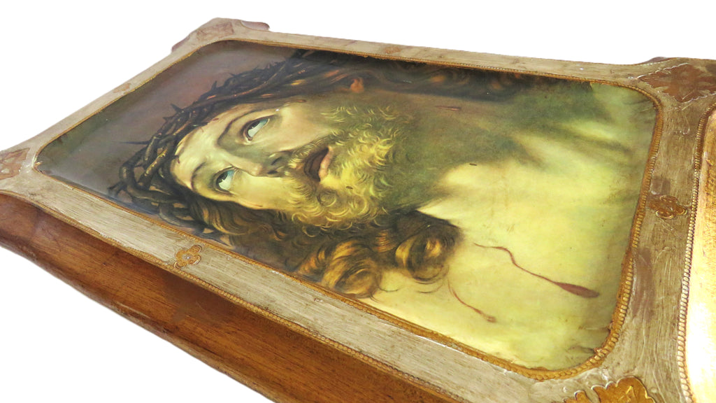 Decorative plaque with Christ design in a gold frame on a white background