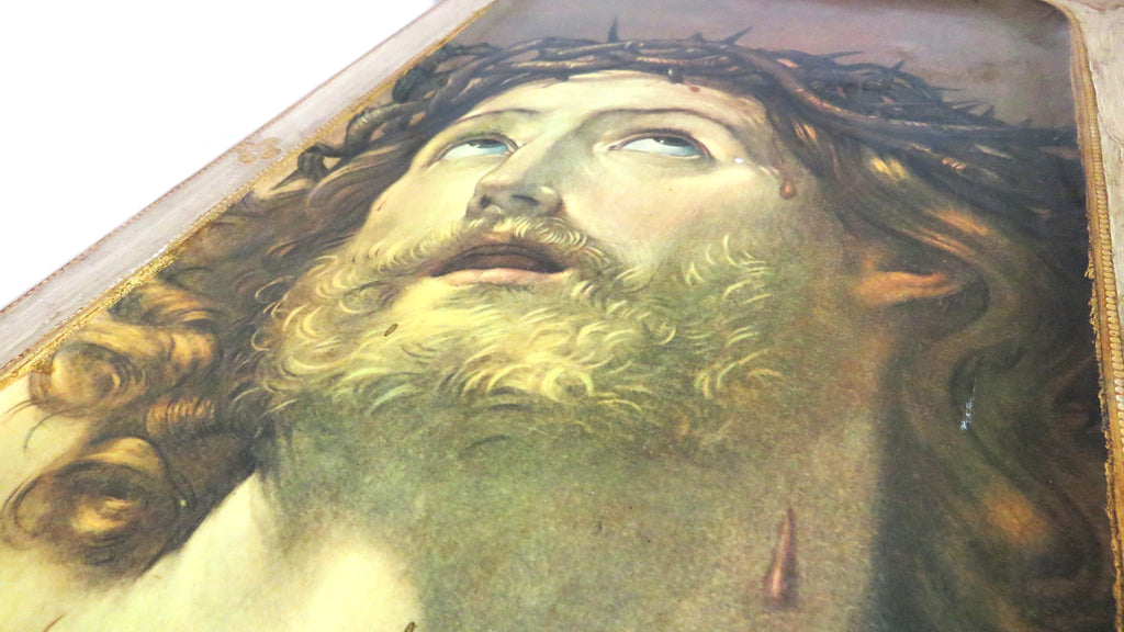 Close-up of a classical painting of a Christ with a crown of thorns.