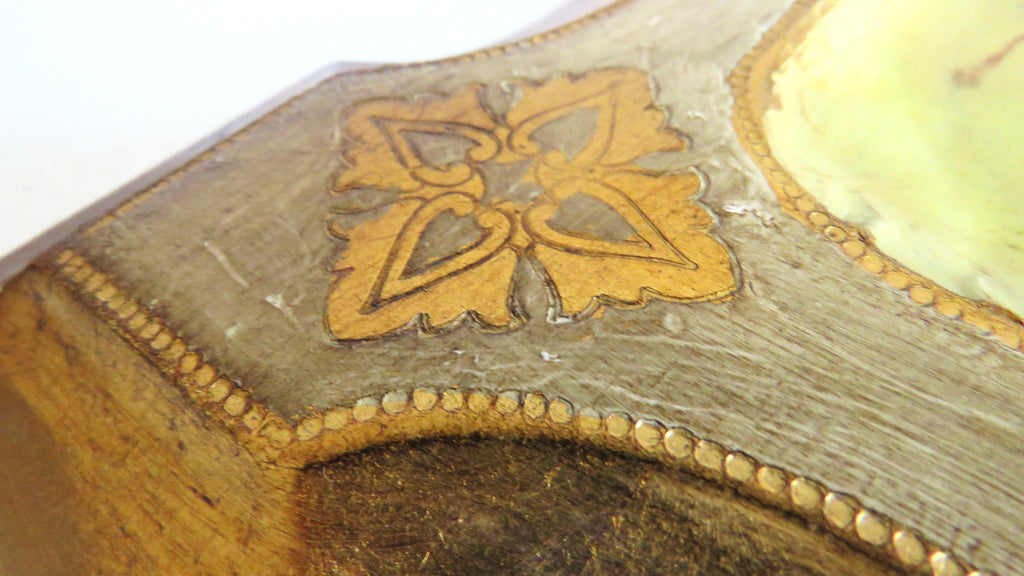 Close-up of a decorative object with gold inlay on a white background