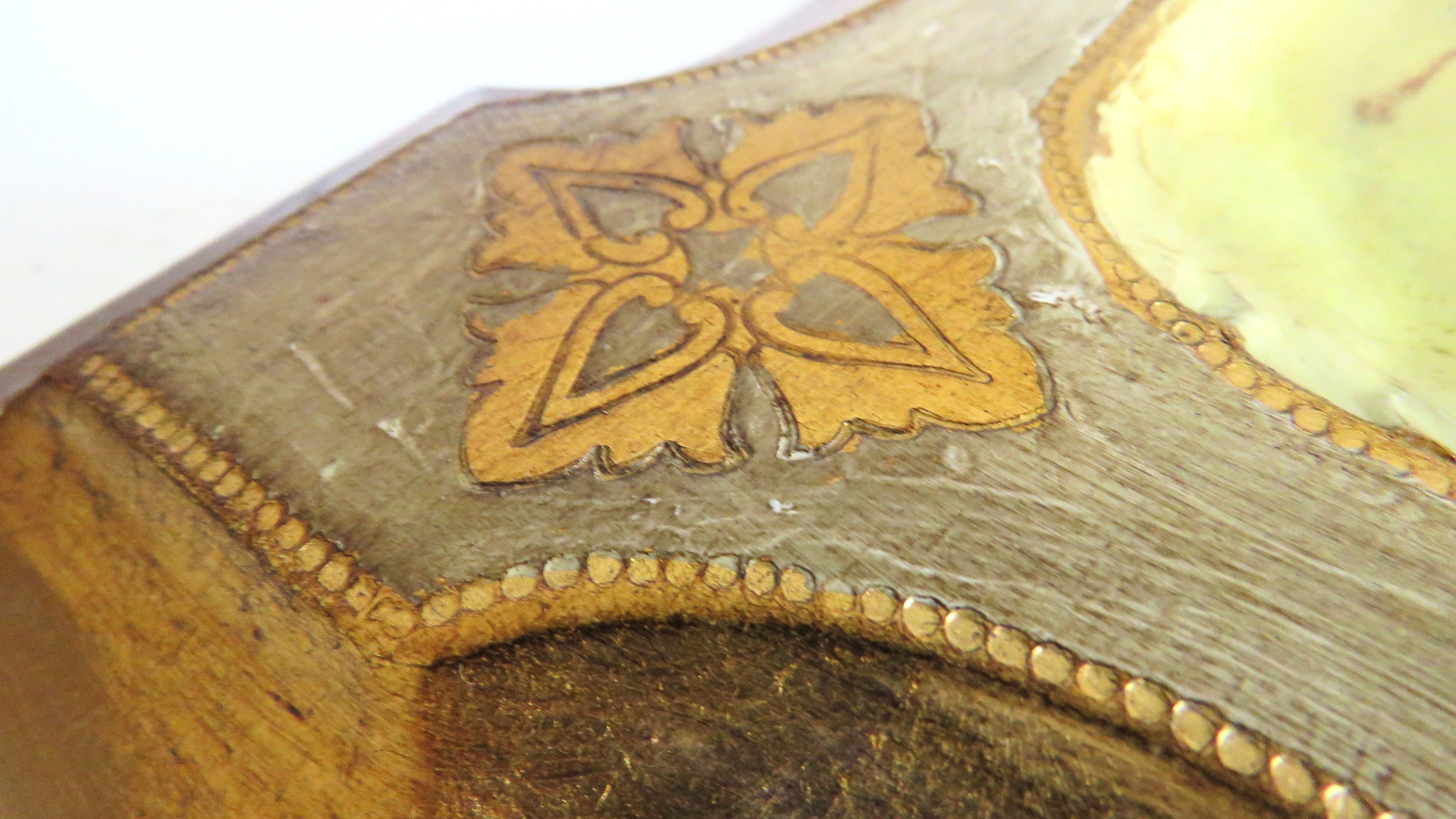 Close-up of a decorative object with gold inlay on a white background
