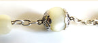 m other of pearl and silver bead on a white background