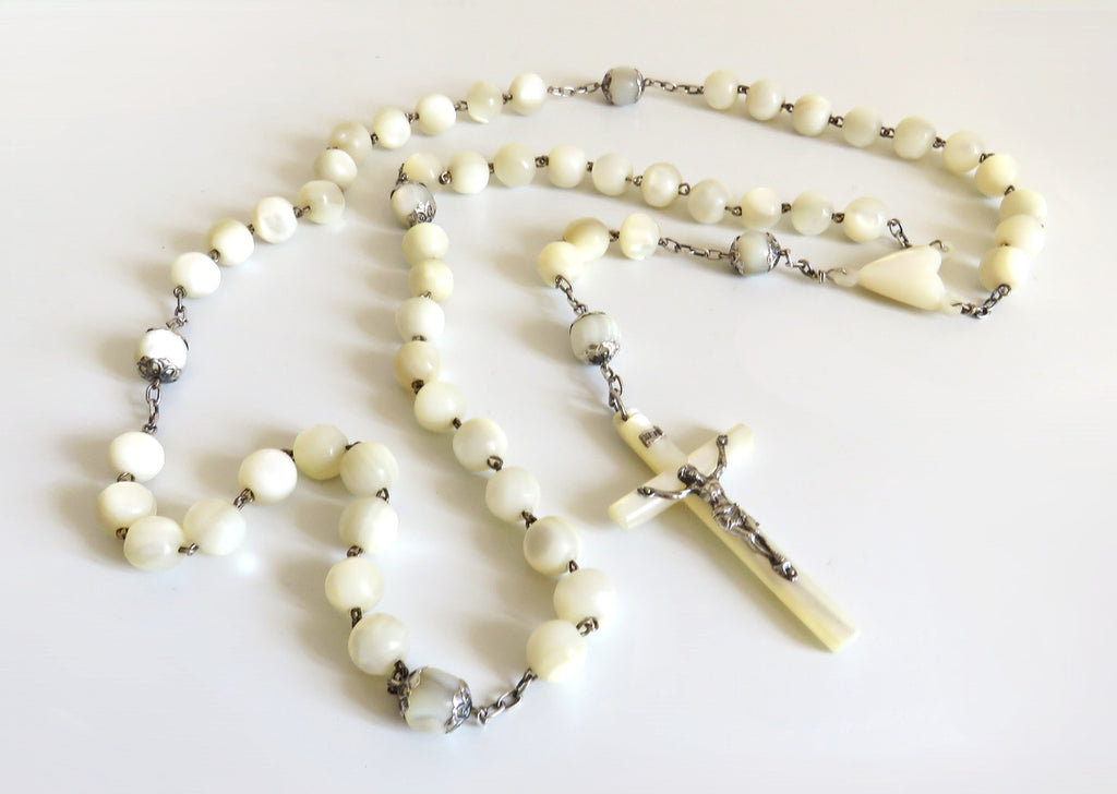 Mother of pearl rosary with large beads on a  white background