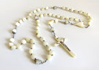 Mother of pearl rosary with large beads on a  white background
