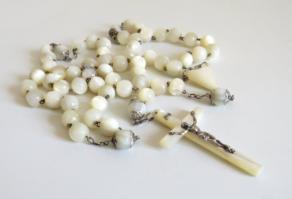 Mother of pearl rosary with large beads on a  white background