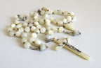 Mother of pearl rosary with large beads on a  white background