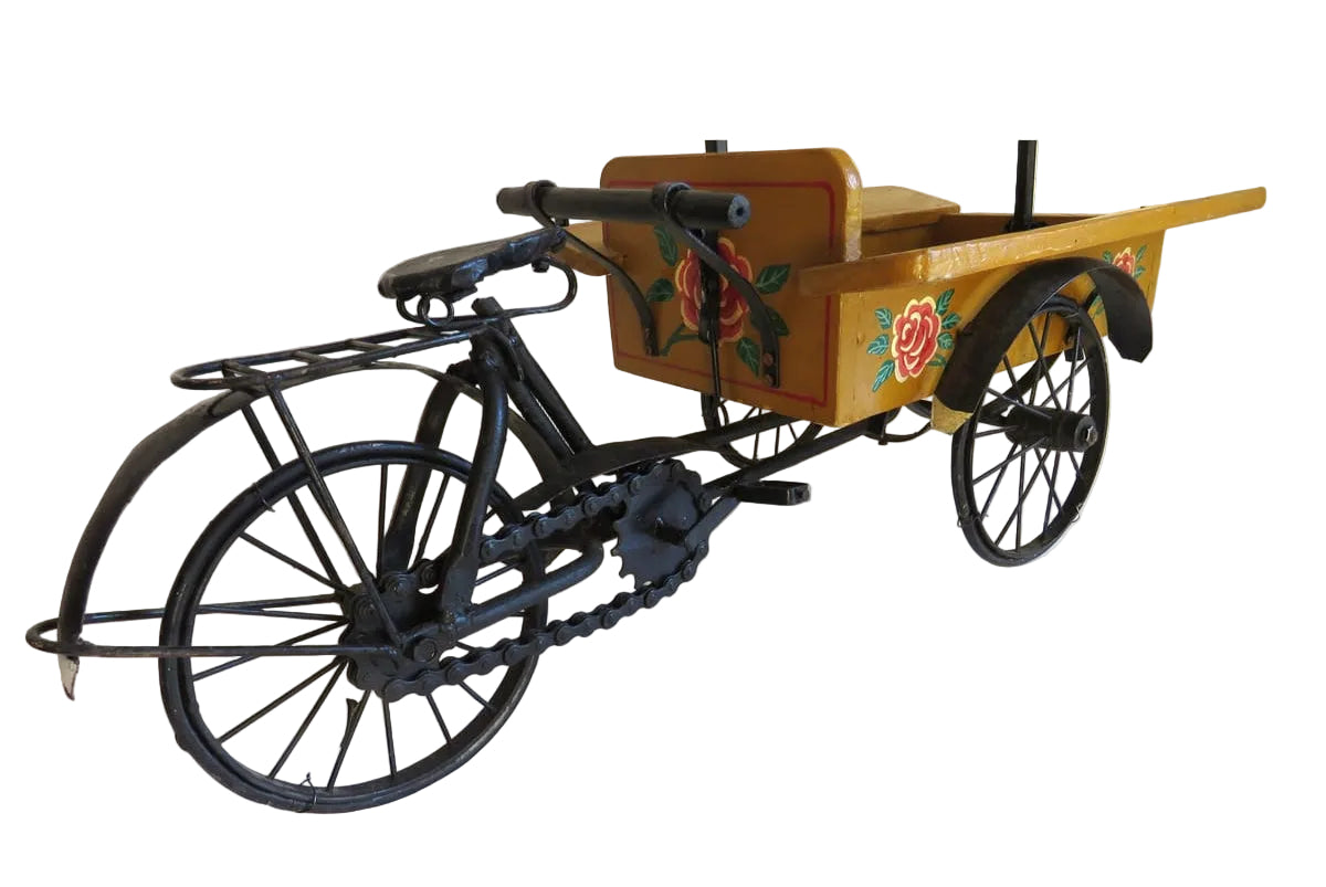 Model of a tricycle with wooden cart and black frame on a white background