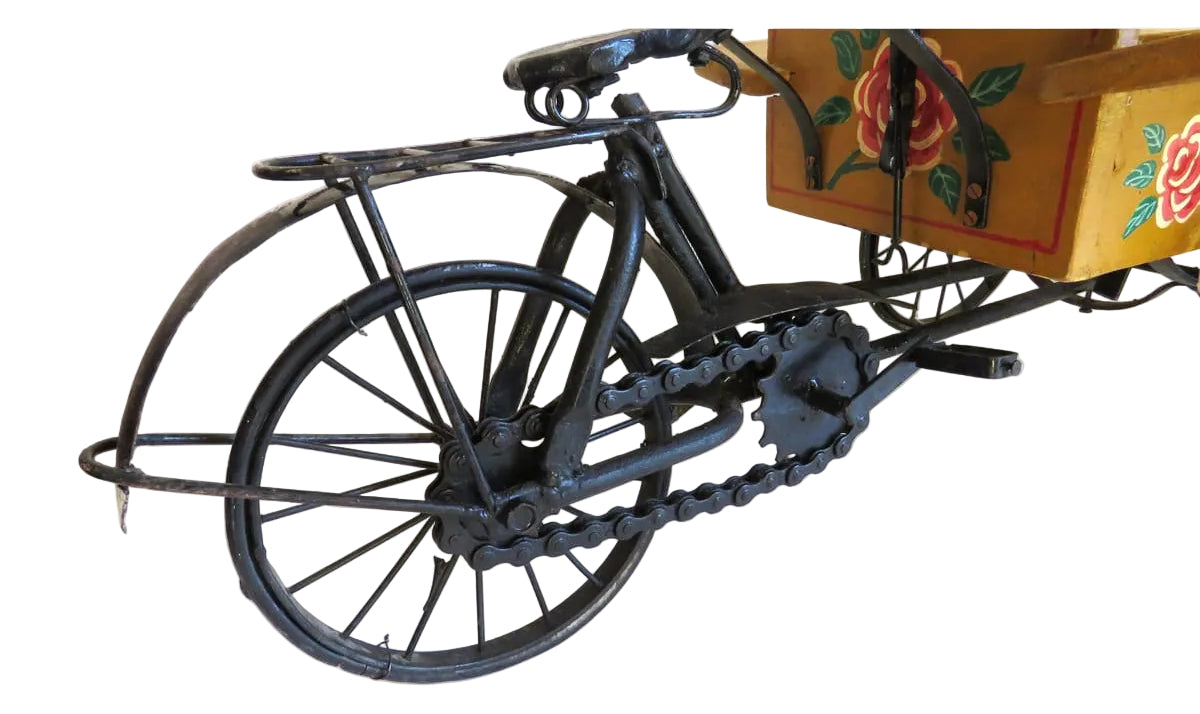 Vintage-style toy bike with a wooden cart on a white background