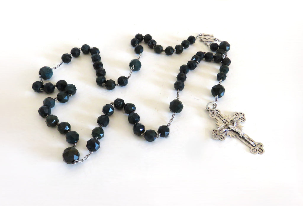 Bloodstone green rosary with a silver crucifix on a white background