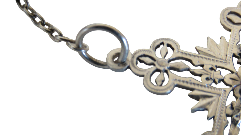 Hallmark and closeup of the top of a silver crucifix