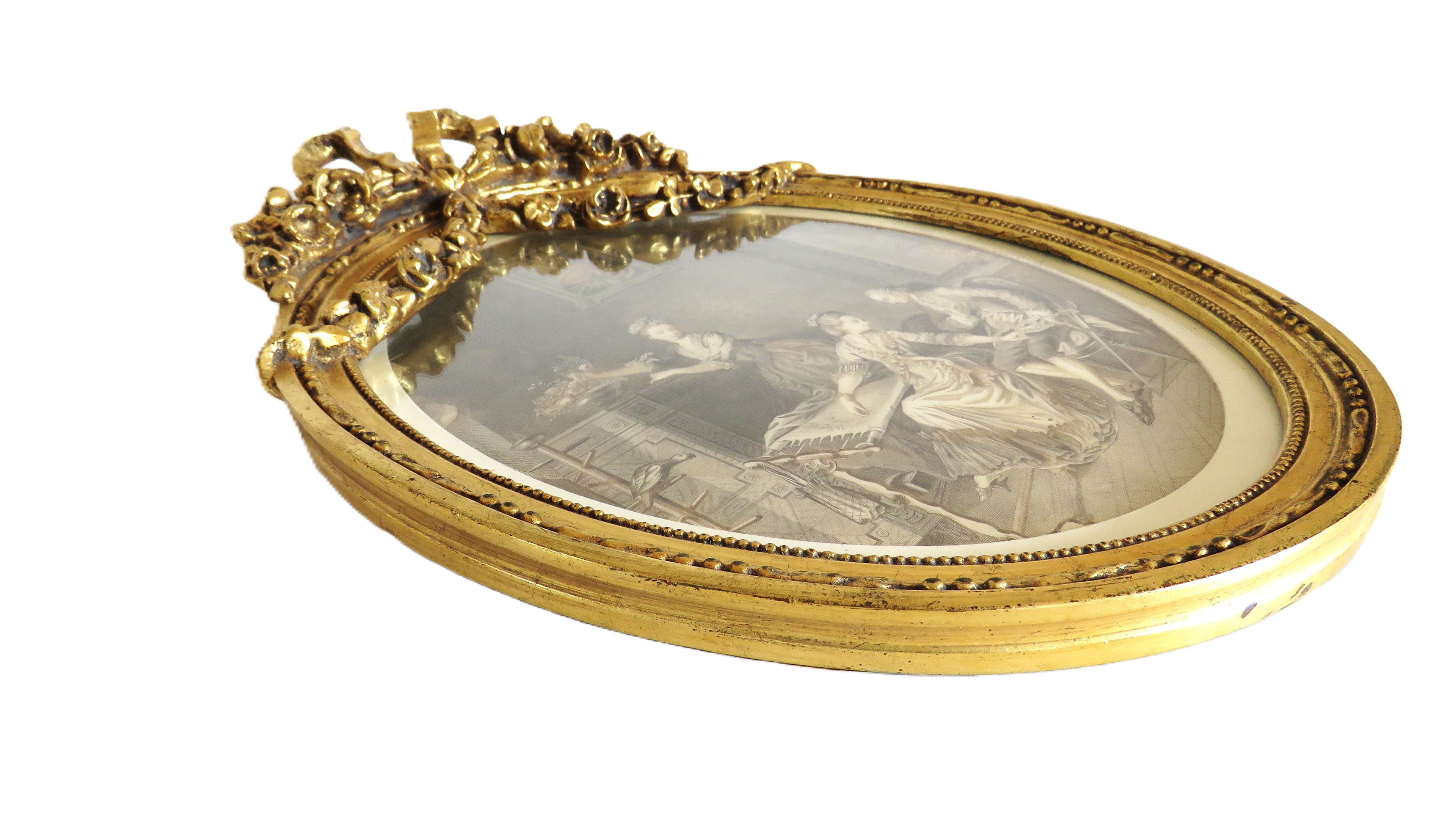 Decorative gold frame with a central oval mirror featuring classical scenes.