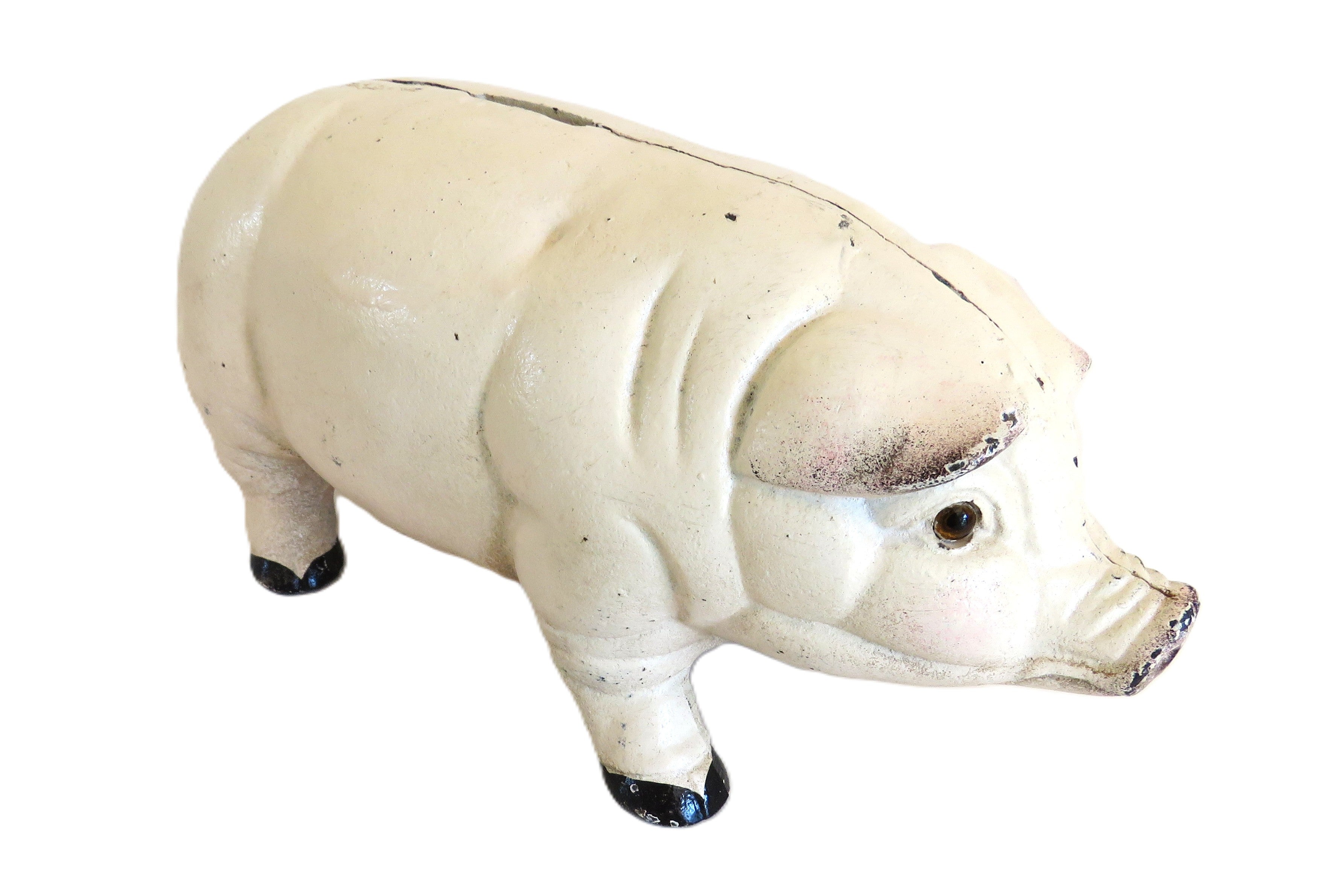 White cast iron piggy bank on a white surface