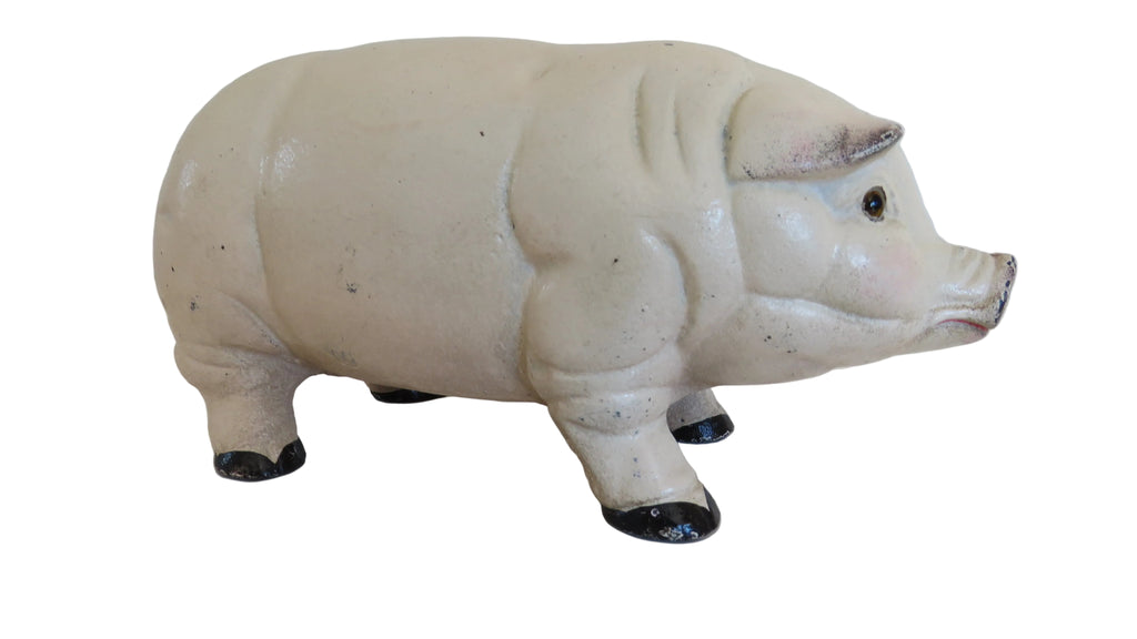 White cast iron piggy bank on a white surface