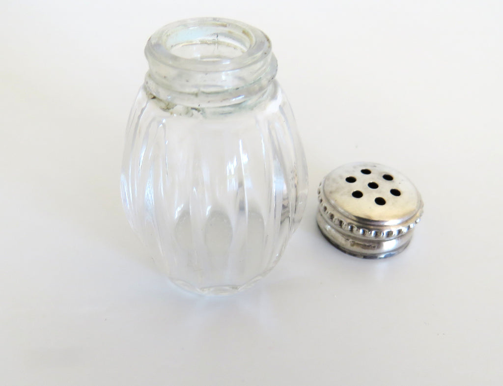 one silver and glass salt cellar with top off