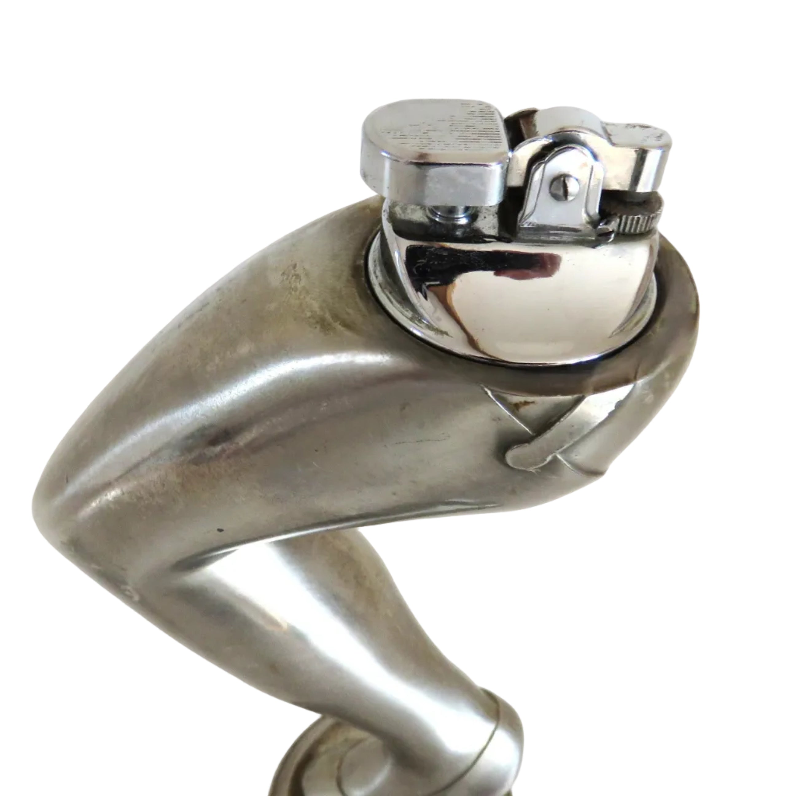 A cigarette lighter on a metallic silver sculpture of a bent leg wearing a high heel, standing on a round base against a plain white background.