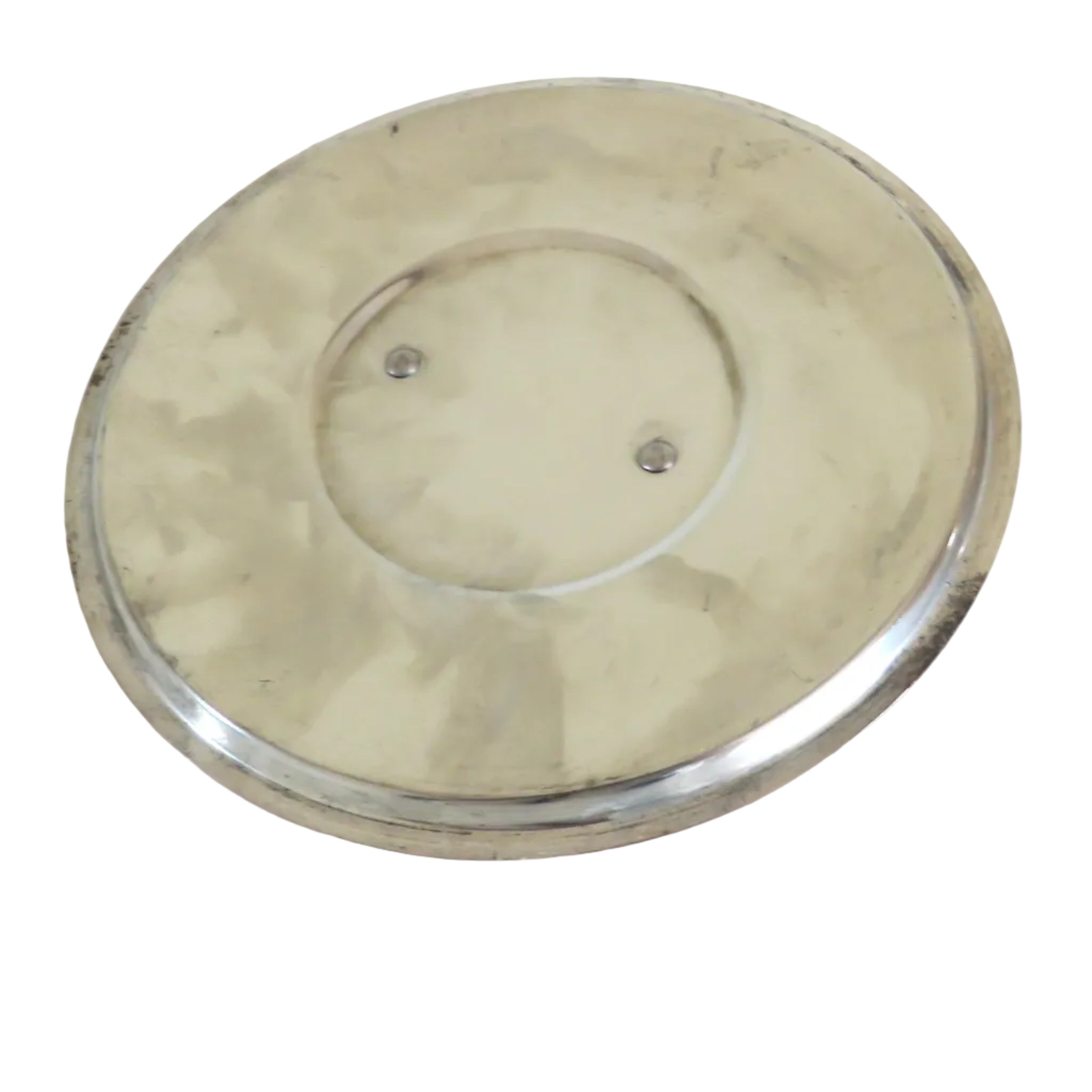 A round, metallic silver plate or shallow dish with a brushed finish, displayed on a white wooden surface.