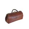 A brown leather medical-style doctors bag with a top handle and metal clasp, sitting on a white surface against a white wall.