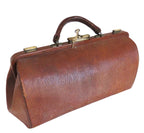 A vintage brown leather doctor's bag or briefcase with a top handle, brass hardware, and a lock clasp, shown on a plain white background.