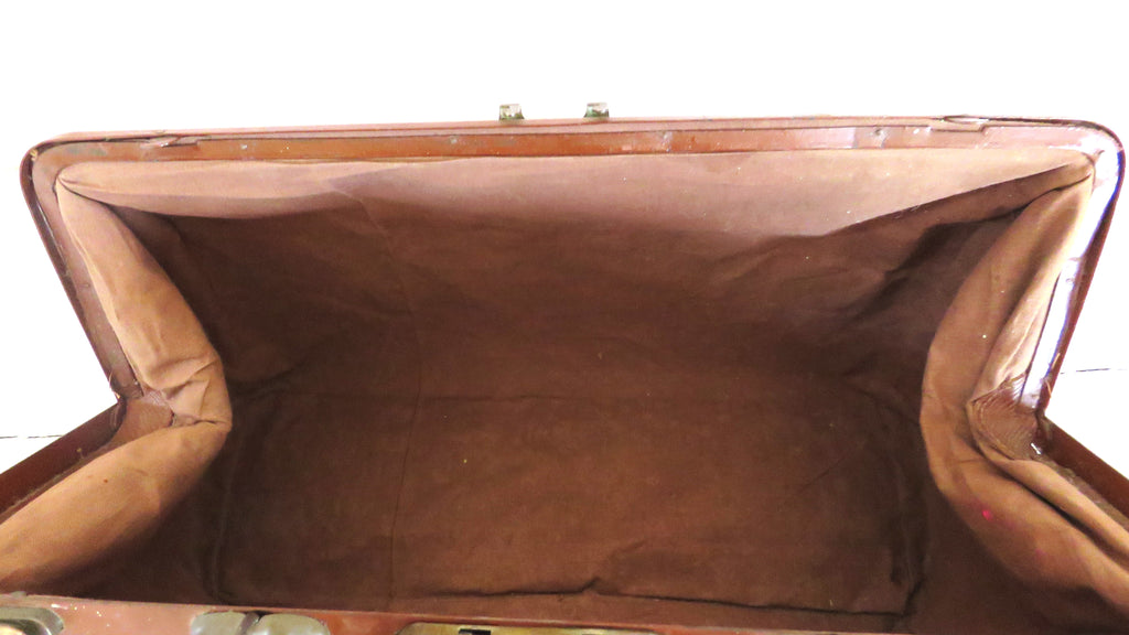 An open vintage brown doctors gladstone bag showing its brown fabric-lined interior, photographed against a plain white background.