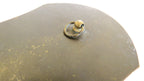 A close-up of a dark metallic surface with a small circular ring detail and a round knob, photographed against a white background.