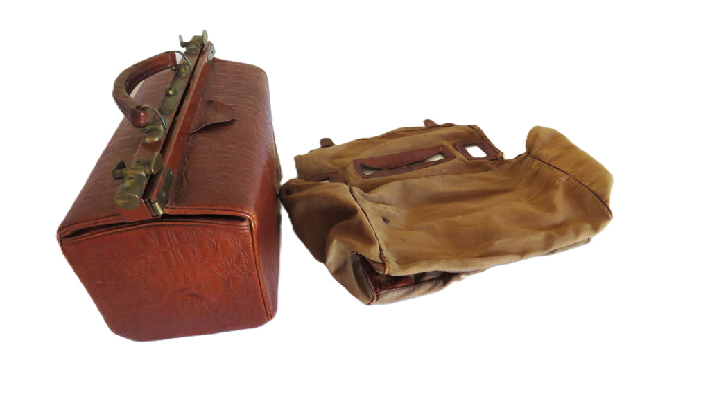 Two vintage leather bags on a white background: a brown embossed leather case with brass hardware on the left, and a canvas cover bag on the right