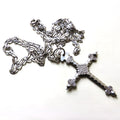 silver cross and chain on white background
