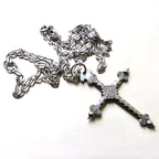 silver cross and chain on white background
