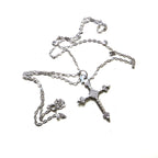 silver cross and chain on white background

