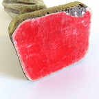 bottom of a figurine with chip on white background