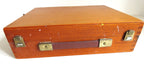 A vintage wooden art box with a warm brown wood grain finish, featuring a dark reddish-brown handle and brass-tone metal latches on a white background.