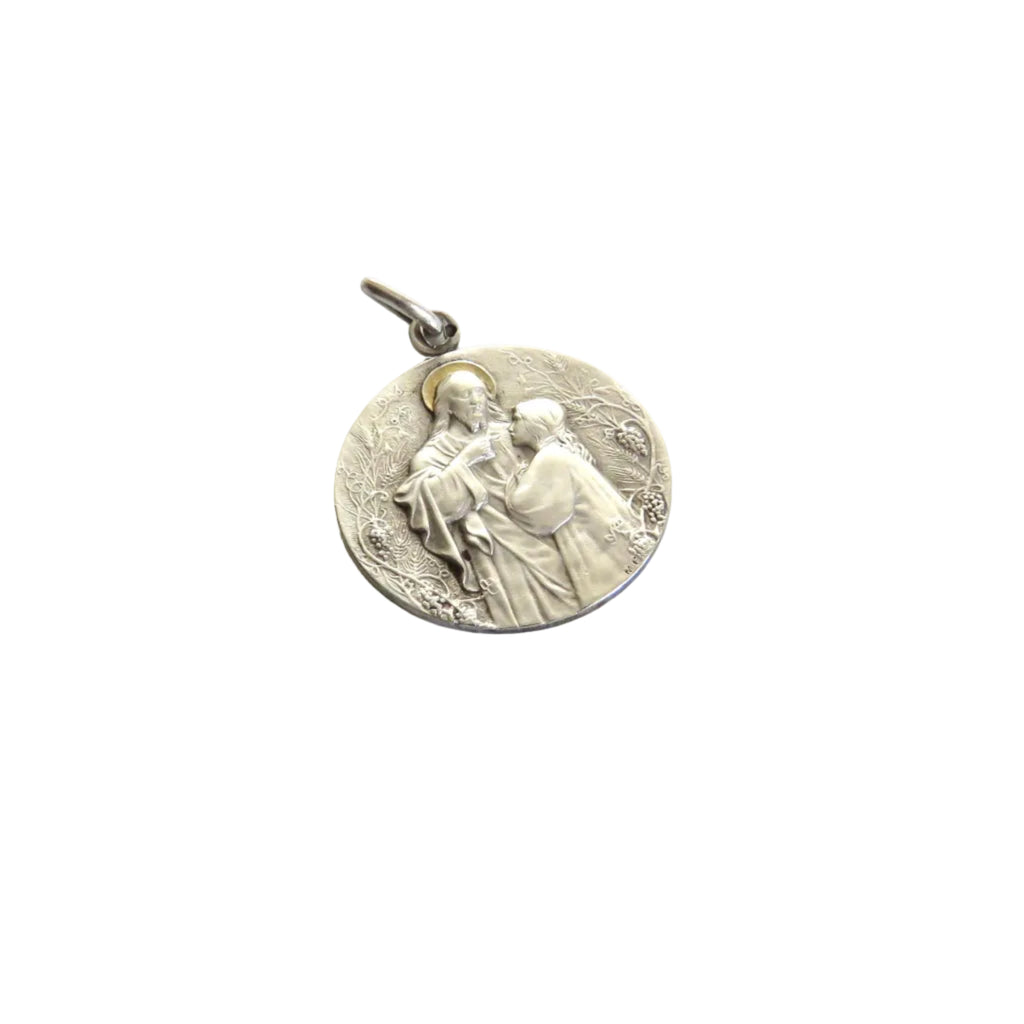 A round silver First Communion medal pendant with a small bail at the top, shown on a plain white background.