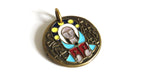 A round antique-style metal pendant with an embossed figure and colorful enamel details in blue, red, yellow, and white, set against a plain white background.