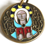 A round antique-style religious pendant or medallion with a bronze-toned metal base, featuring enamel details in light blue, red, white, and yellow, with a hanging loop at the top.