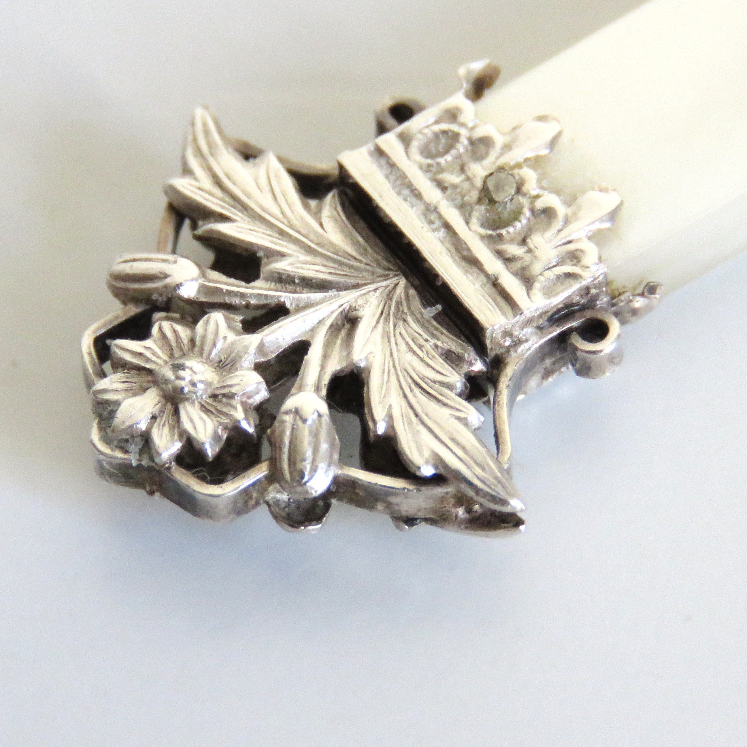 Decorative silver tip on a crucifix on a white background