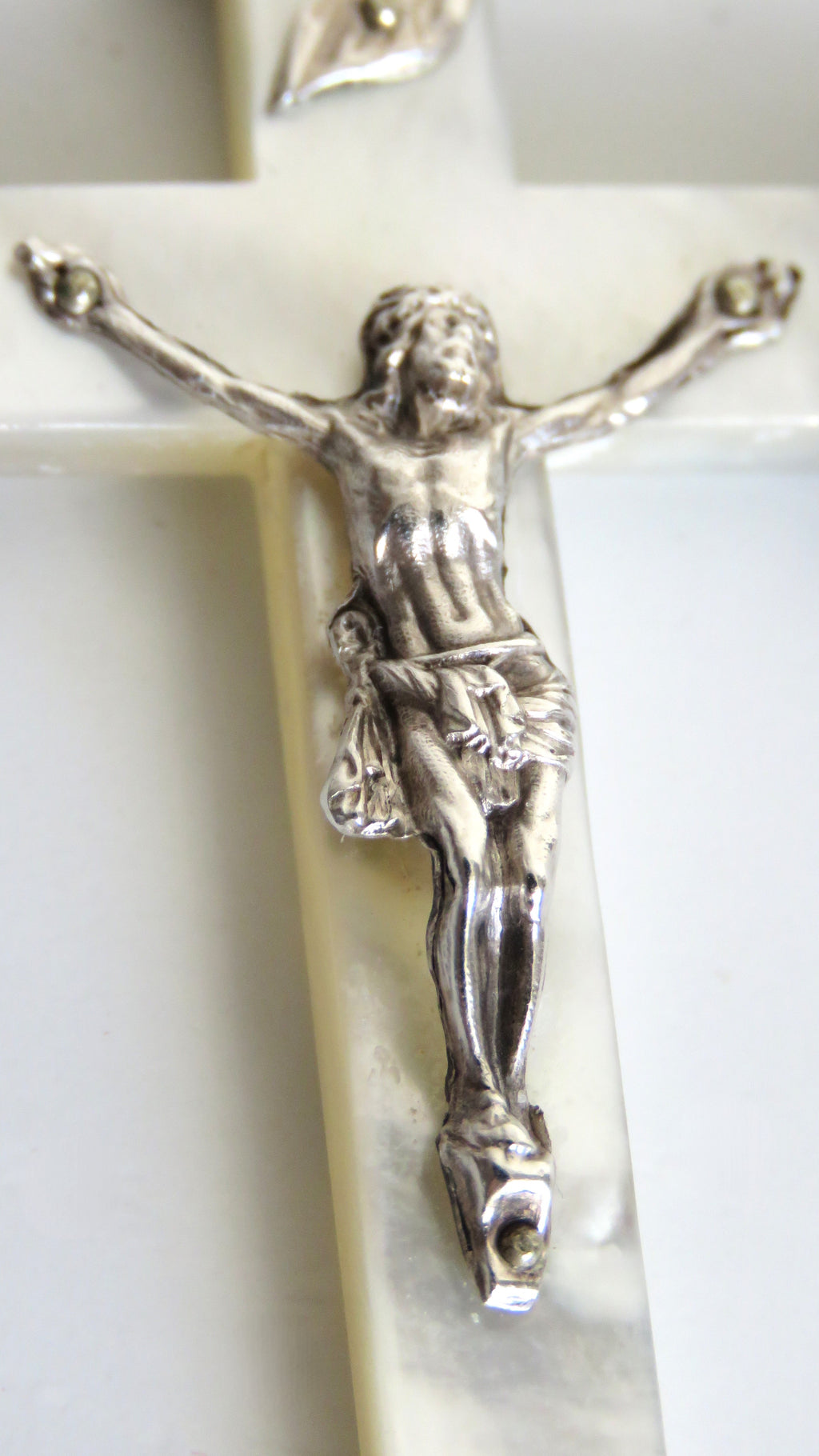 Silver crucifix on a white background