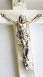 Silver crucifix on a white background