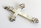 Decorative cross with ornate silver top on a white background